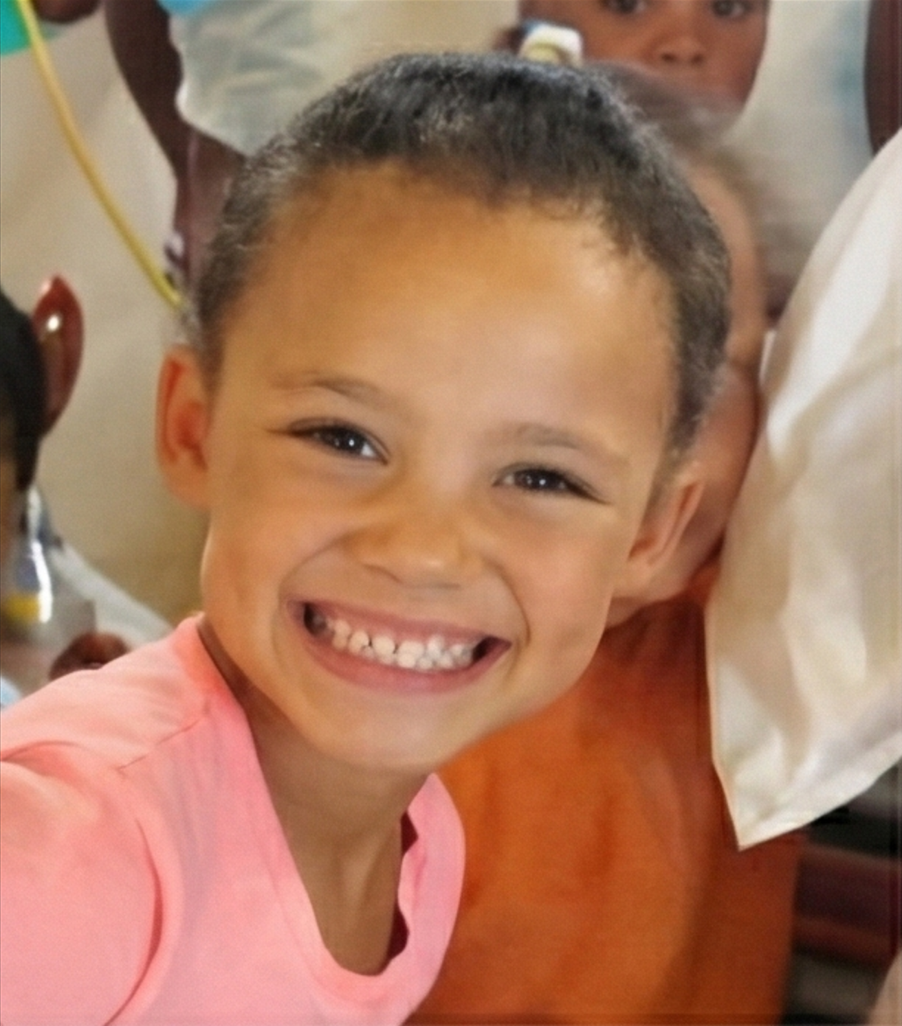 Smiling girl in pink at Kinders vir die Koning